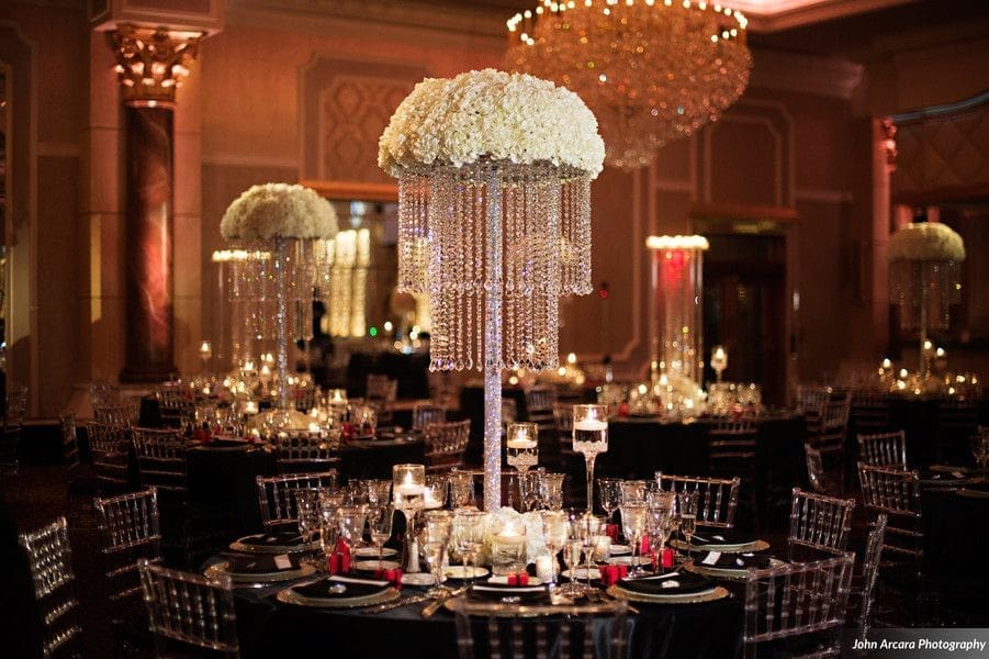 A black and white wedding reception with a chandelier.