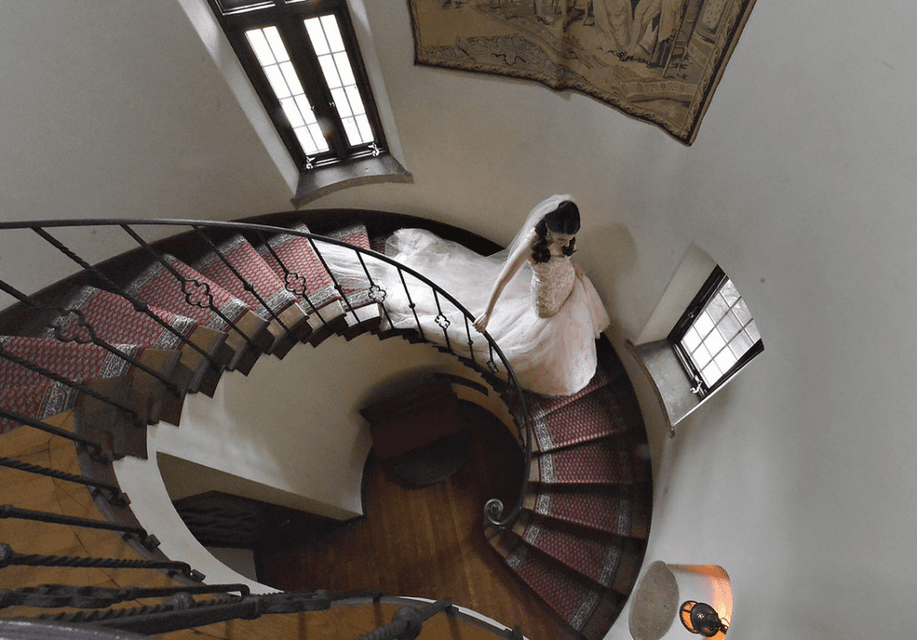 Bride in wedding frock walking through stairs