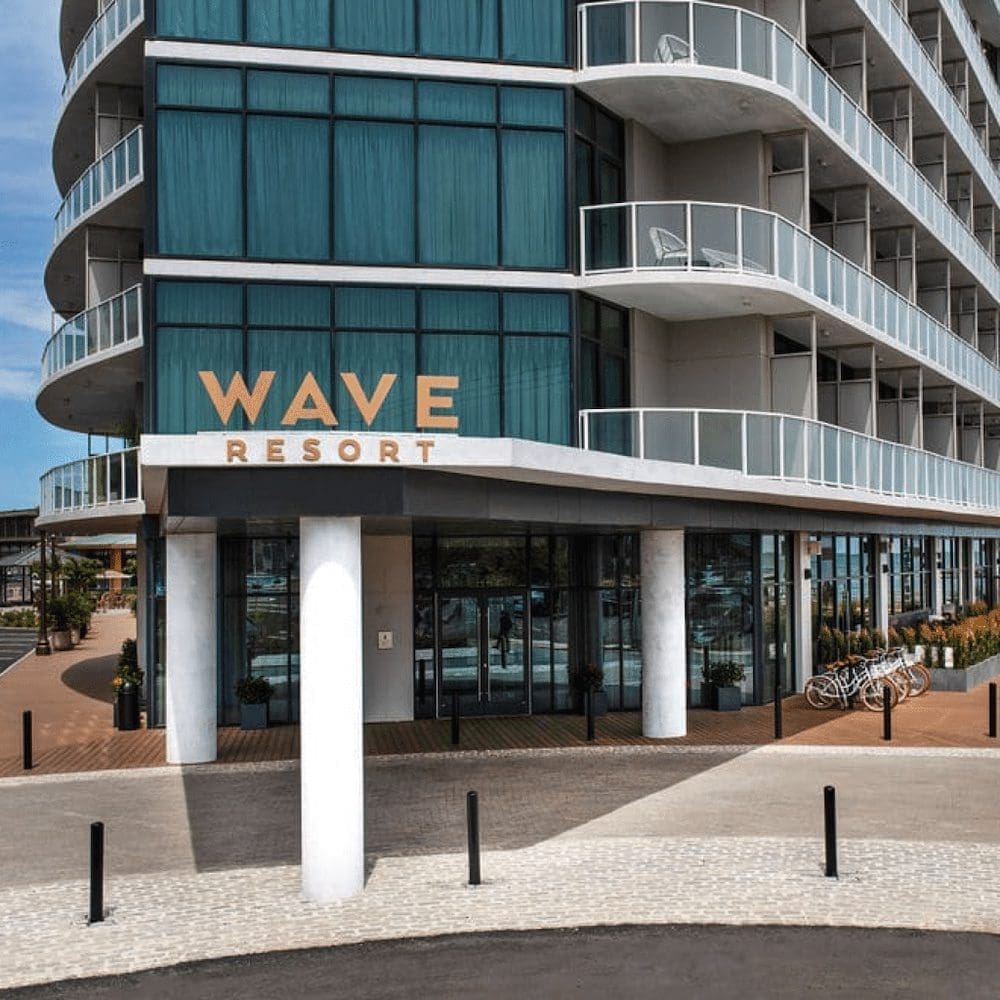A building with a sign that says wave resort.