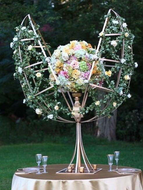 A table with a flower arrangement on top of it.