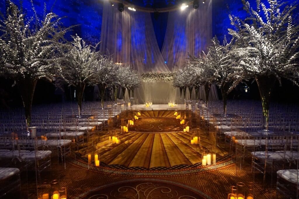A wedding ceremony set up in a dark room with candles.