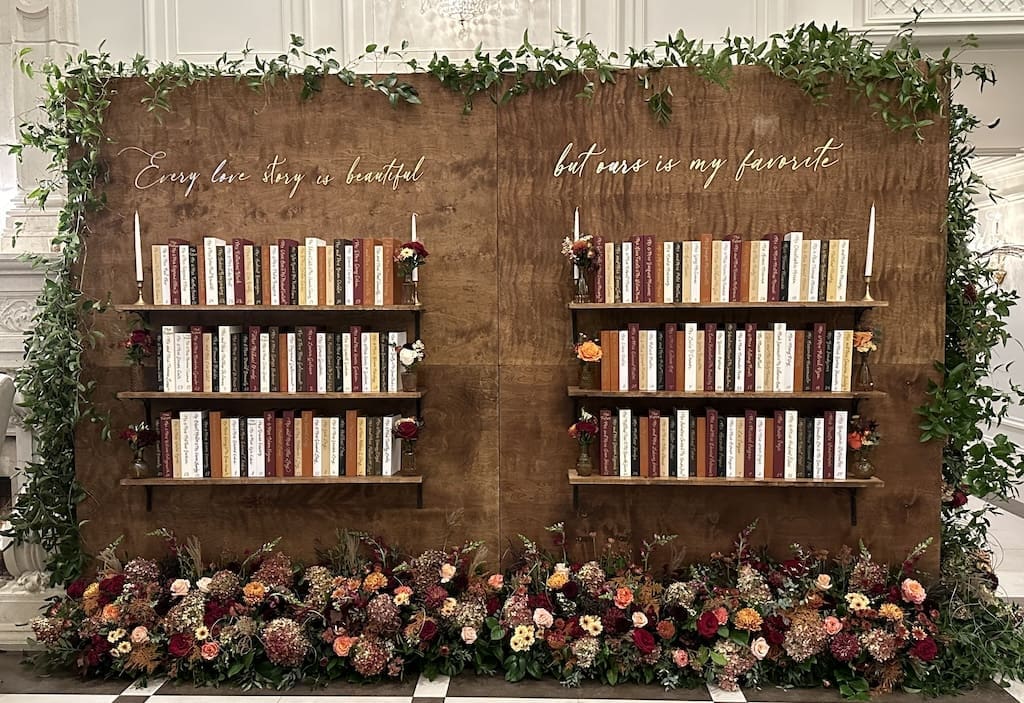 Two bookshelves with flowers on them in a church.
