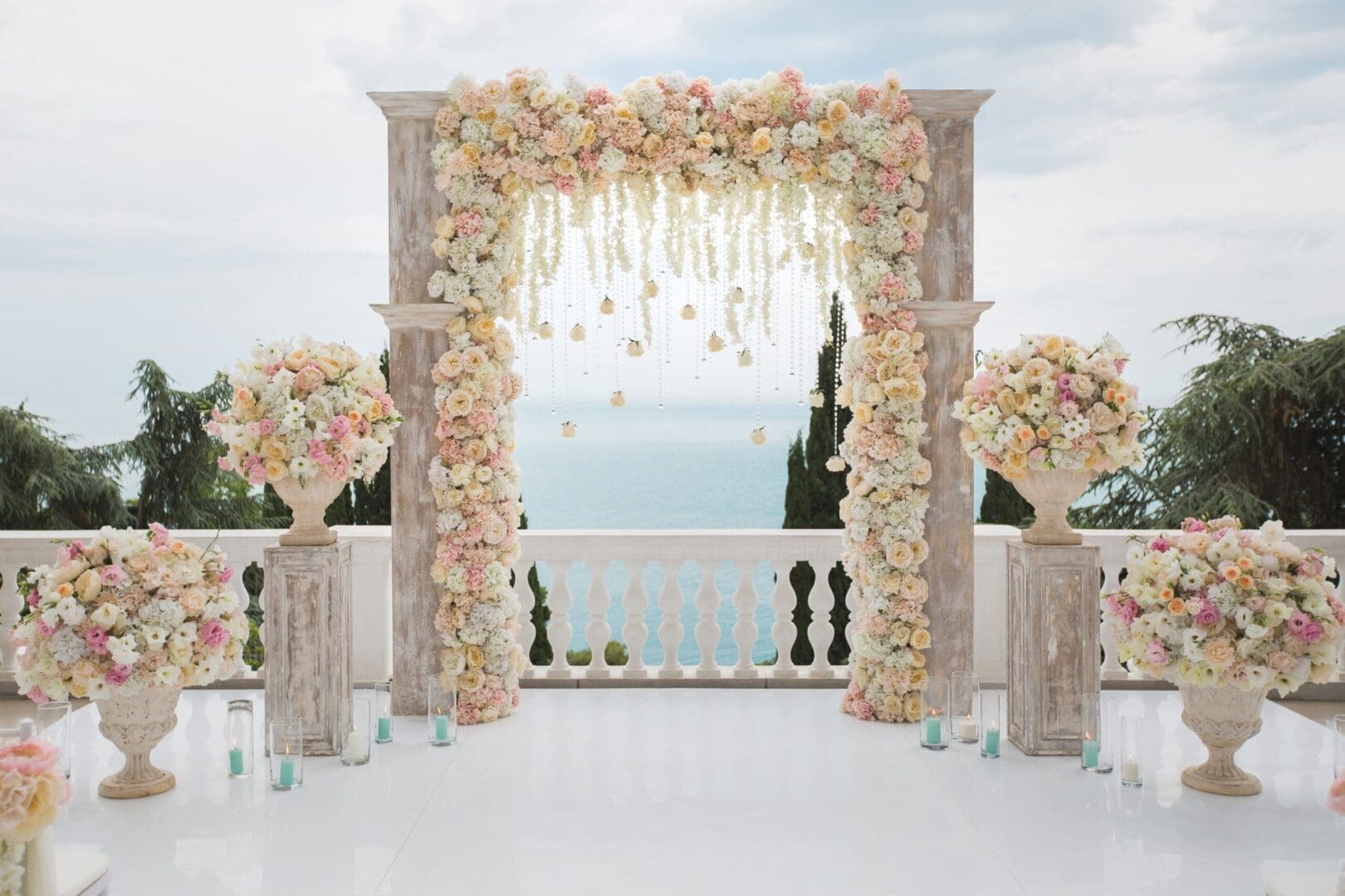 A wedding ceremony set up with flowers and vases.