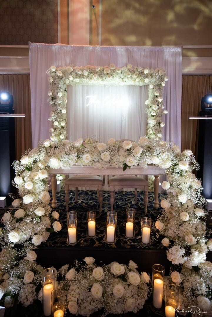 A wedding ceremony set up with white flowers and candles.