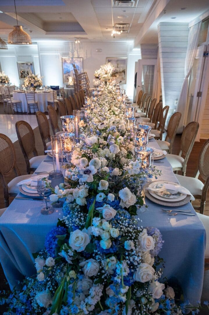 A stunning wedding tablescape adorned with blue and white flowers.