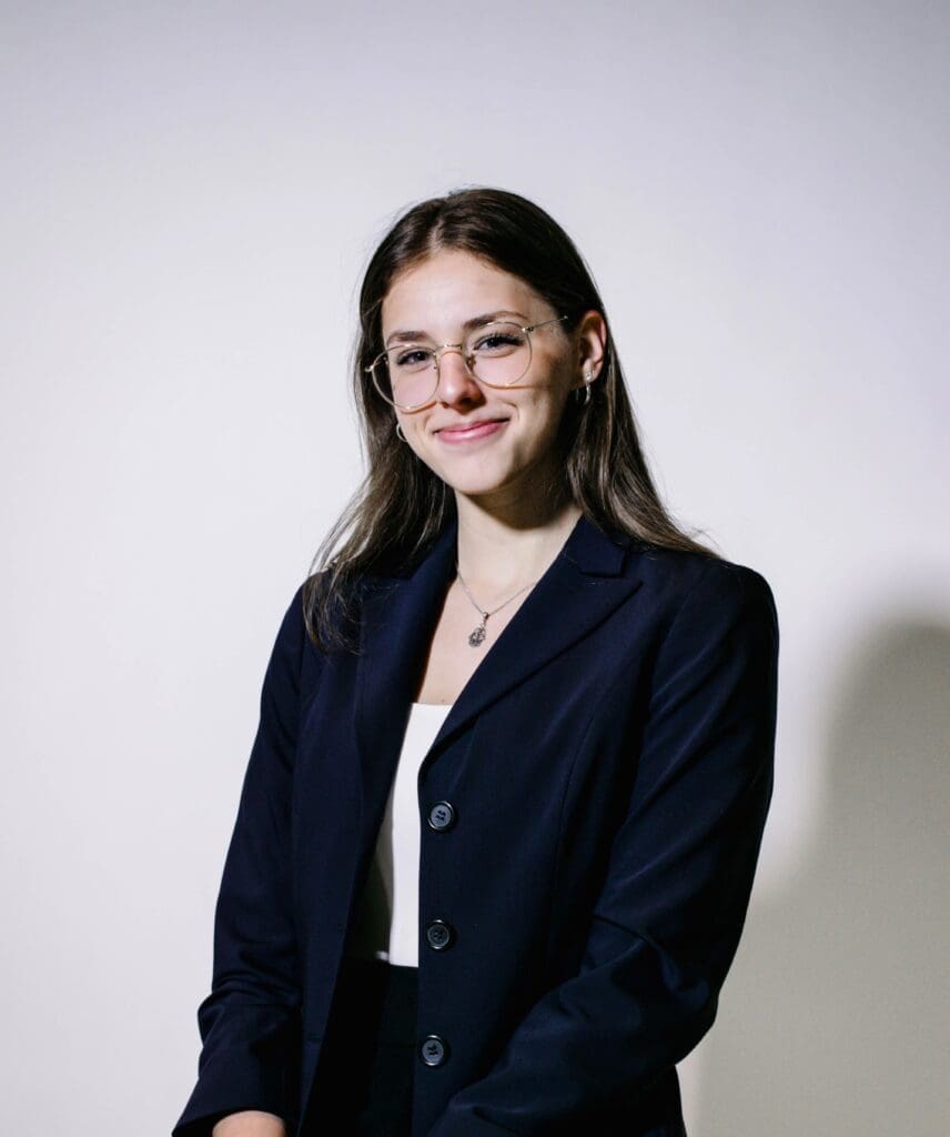 A woman in a business suit posing for a photo.
