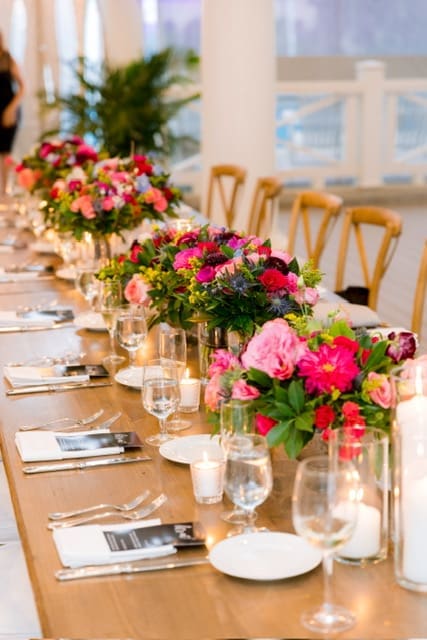 A beautifully decorated wedding tablescape adorned with flowers and candles.