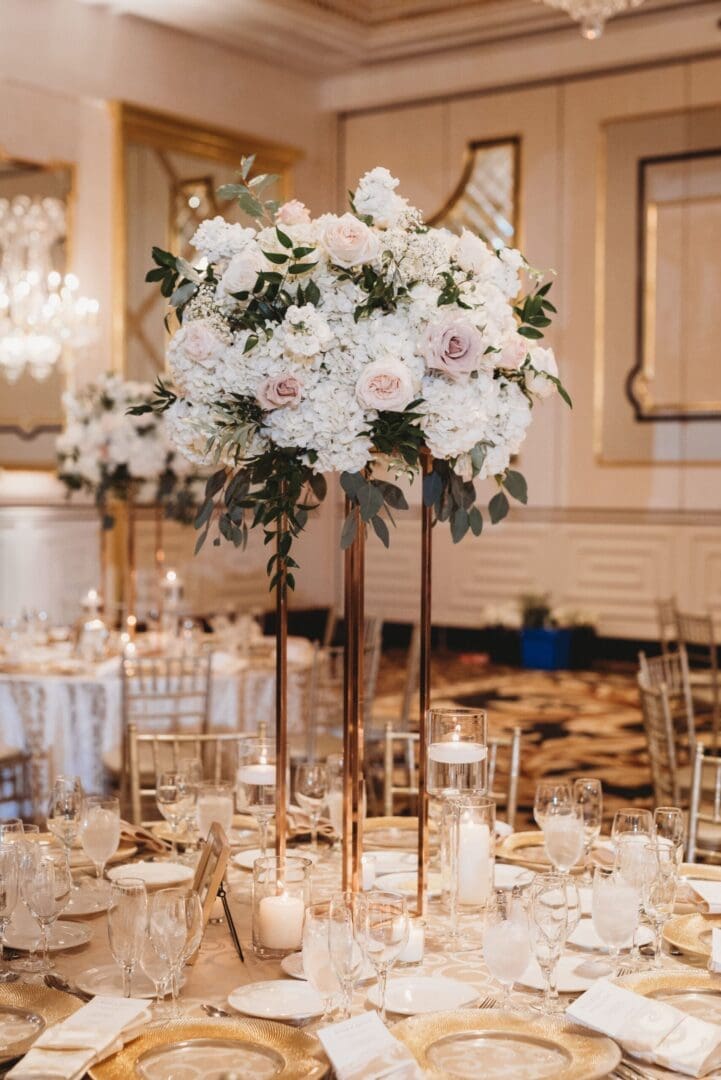 An elegant wedding reception with white flowers and gold centerpieces, featuring stunning wedding tablescape ideas.