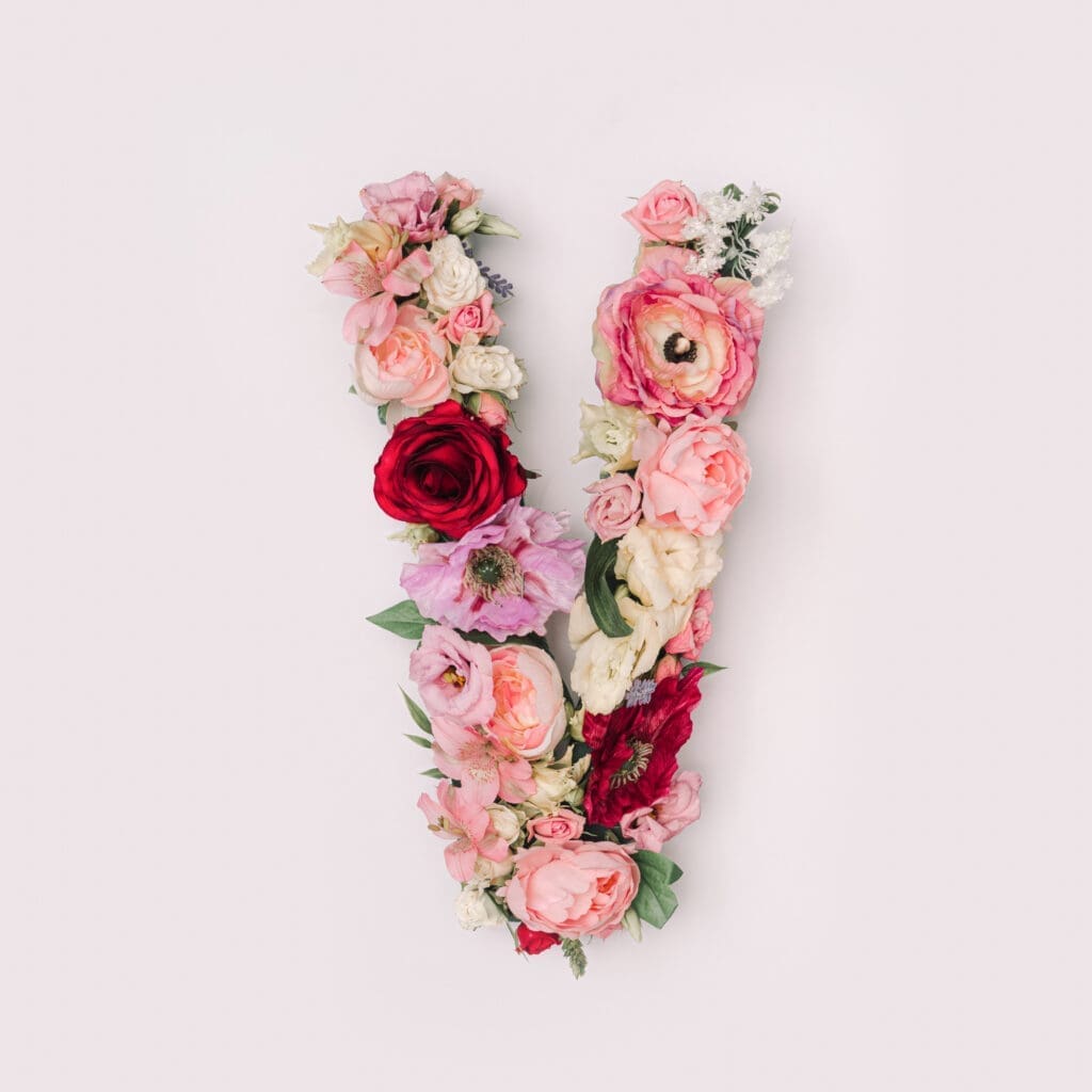 A letter v made of flowers on a white background.