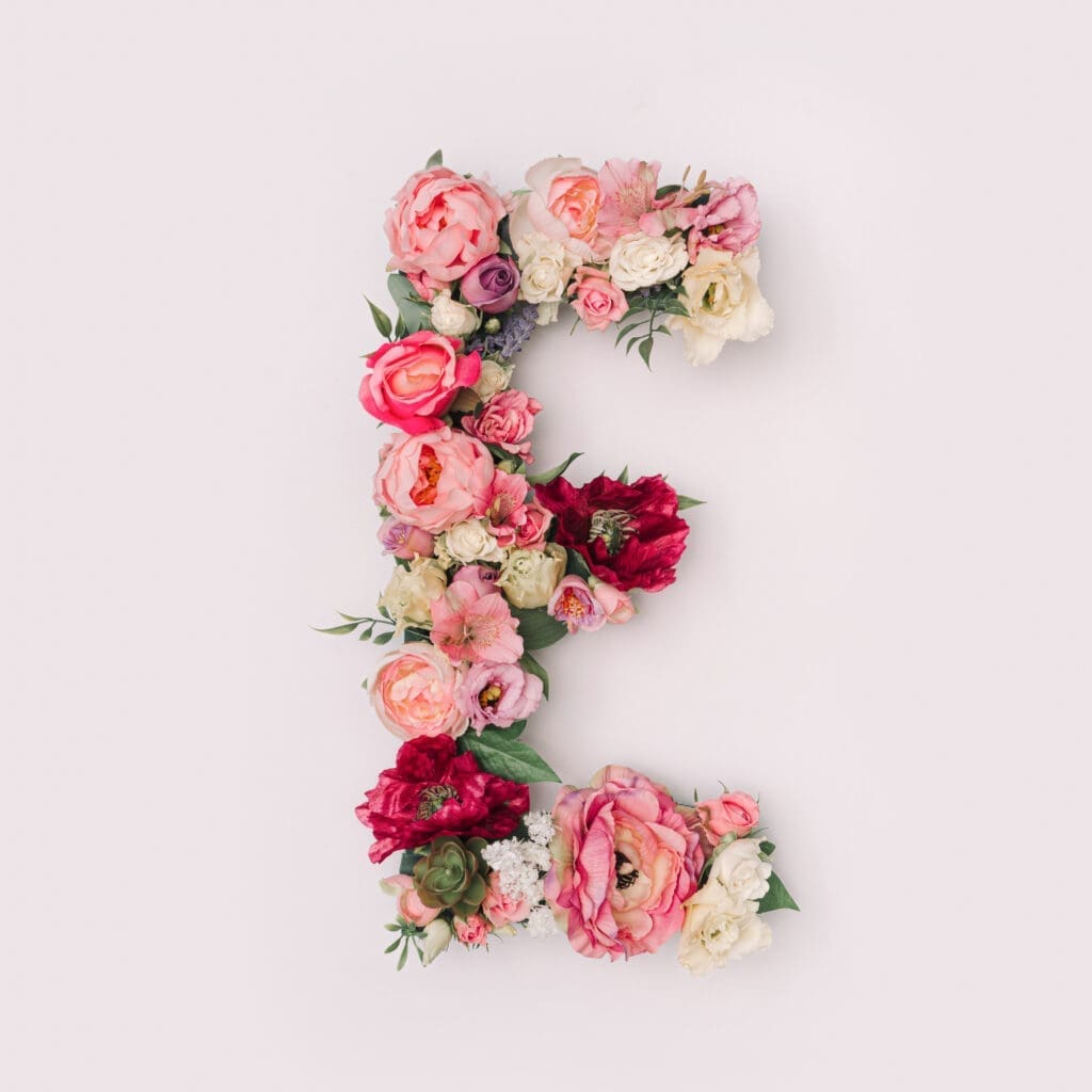 The letter e is made of flowers on a white background.