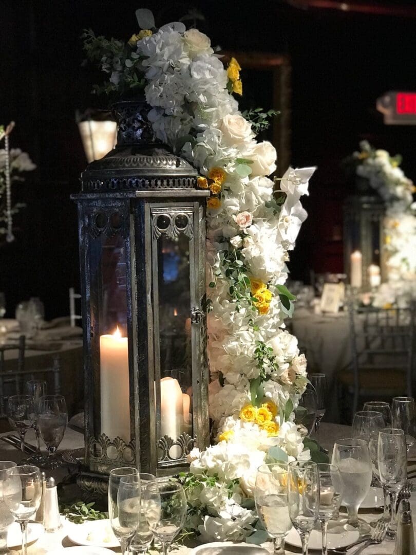 A beautiful wedding table setting featuring a lantern and flowers.