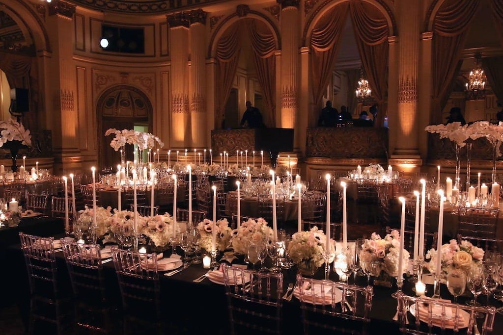 An ornate ballroom filled with candles and wedding tablescape ideas.