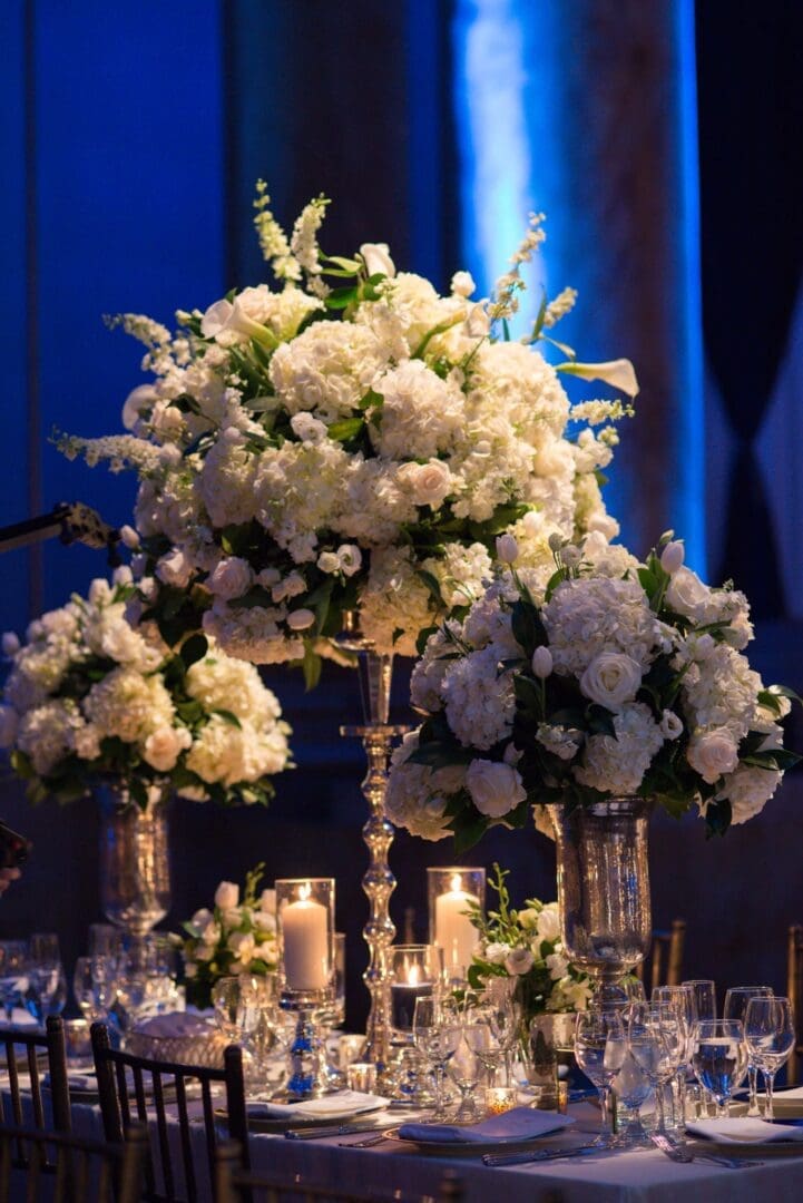 A stunning wedding tablescape with white flowers and candles.