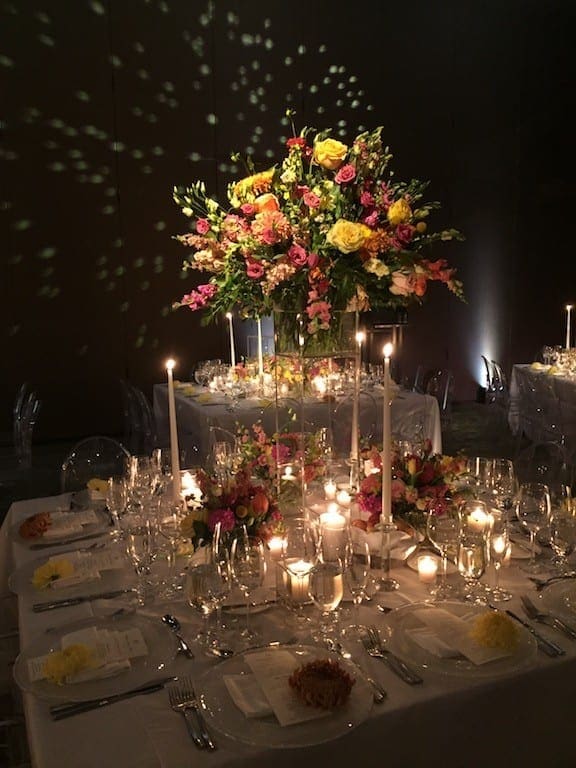 A stunning wedding tablescape adorned with candles and flowers, creating a romantic ambiance.