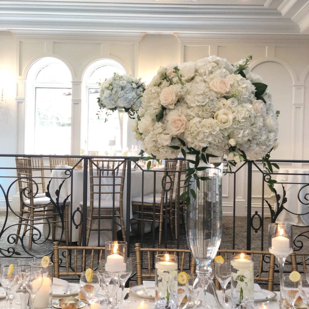 A stunning tablescape idea for a wedding featuring a large white flower arrangement.