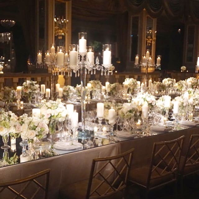 A romantic wedding table scape adorned with candles and flowers.