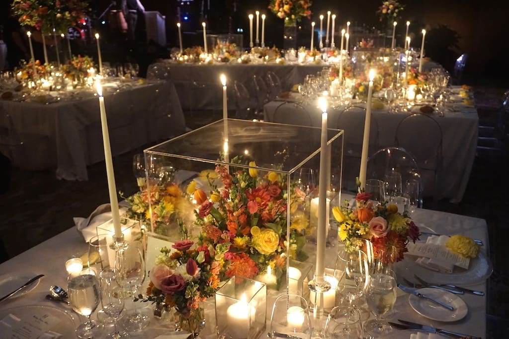 A stunning wedding tablescape adorned with candles and flowers.