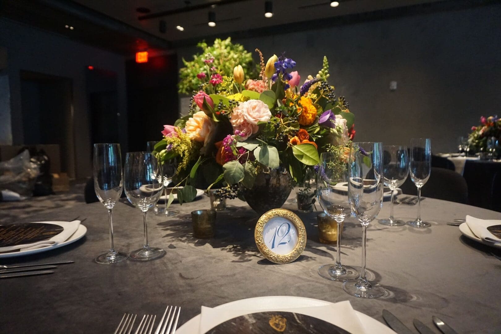 A wedding table scape with flowers and a clock.
