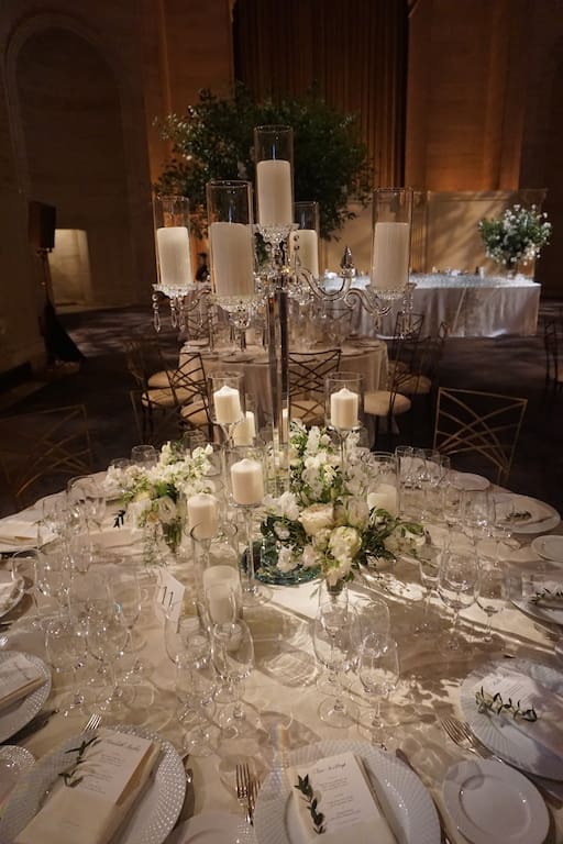 A stunning table scape for a wedding, featuring elegant white flowers and candles.
