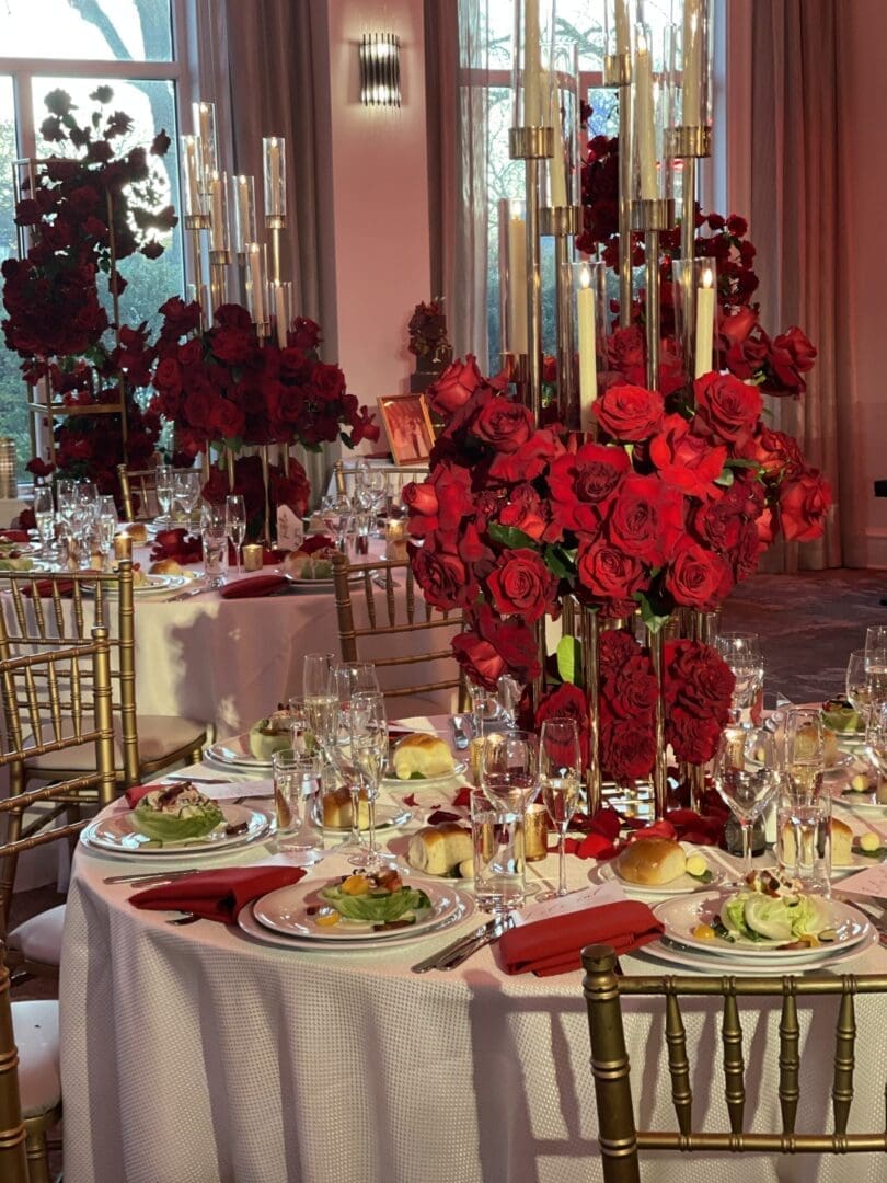 A wedding table scape with red roses.
