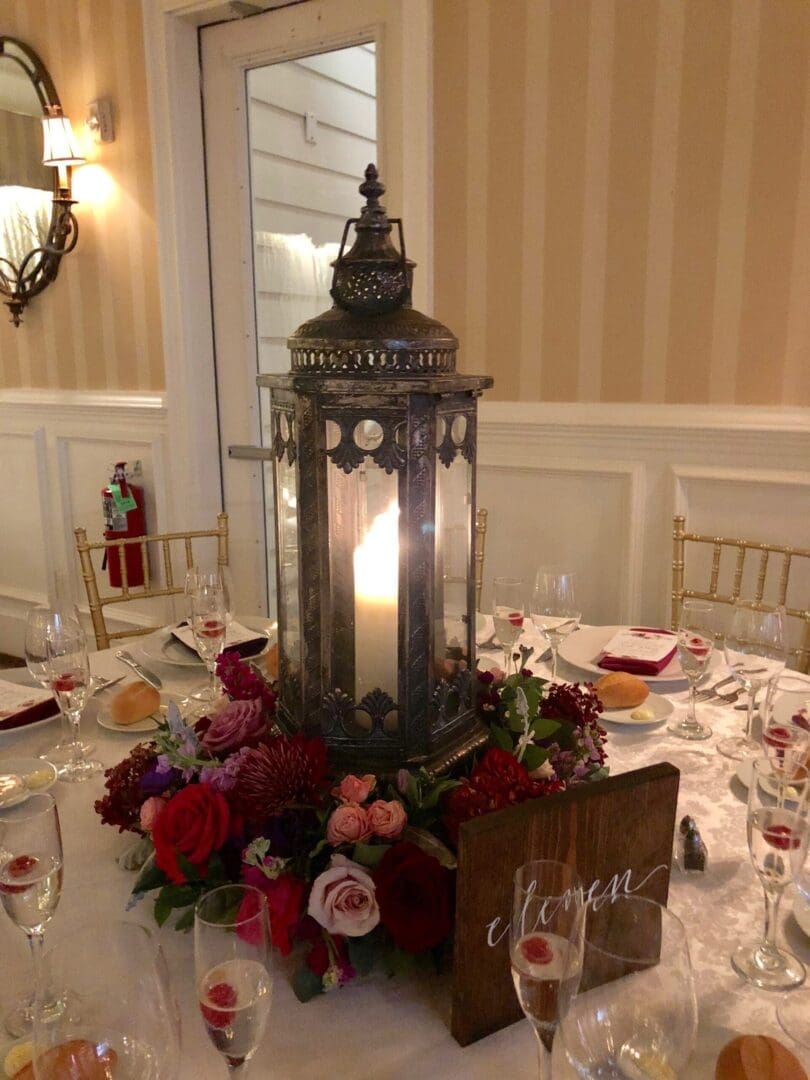 A wedding tablescape featuring a lantern as a centerpiece.