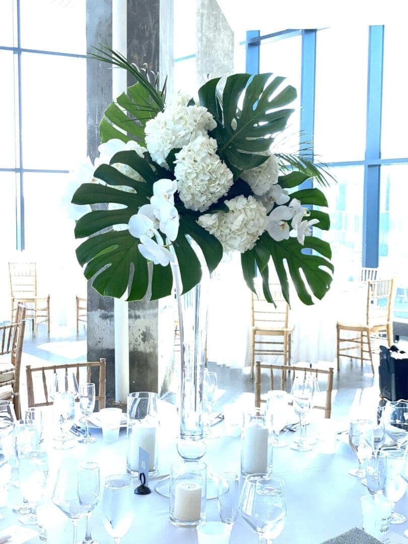 Beautiful white and green flowers arranged in a vase, perfect for wedding table scape ideas.