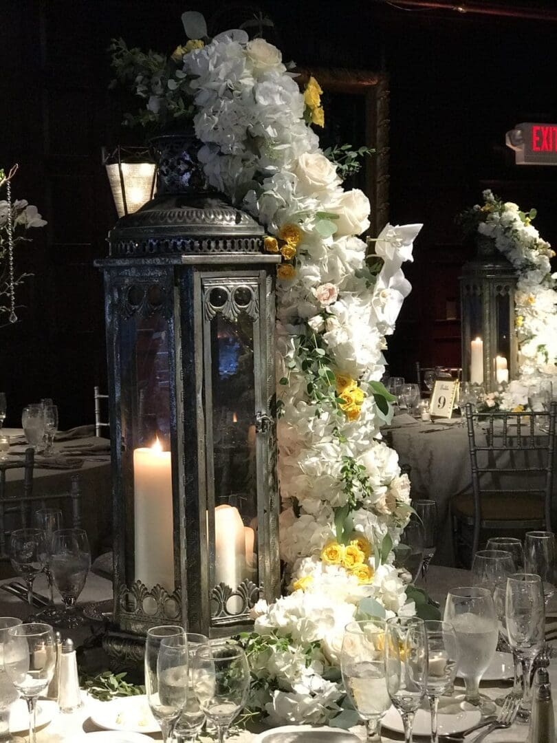 An enchanting wedding table scape adorned with candles and flowers, accentuated with charming lanterns.