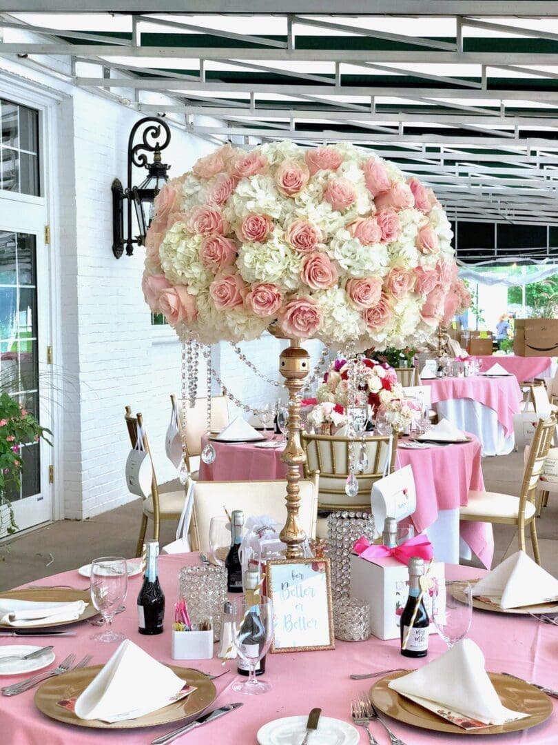 A pink and white table setting with pink flowers, perfect for wedding tablescape ideas.