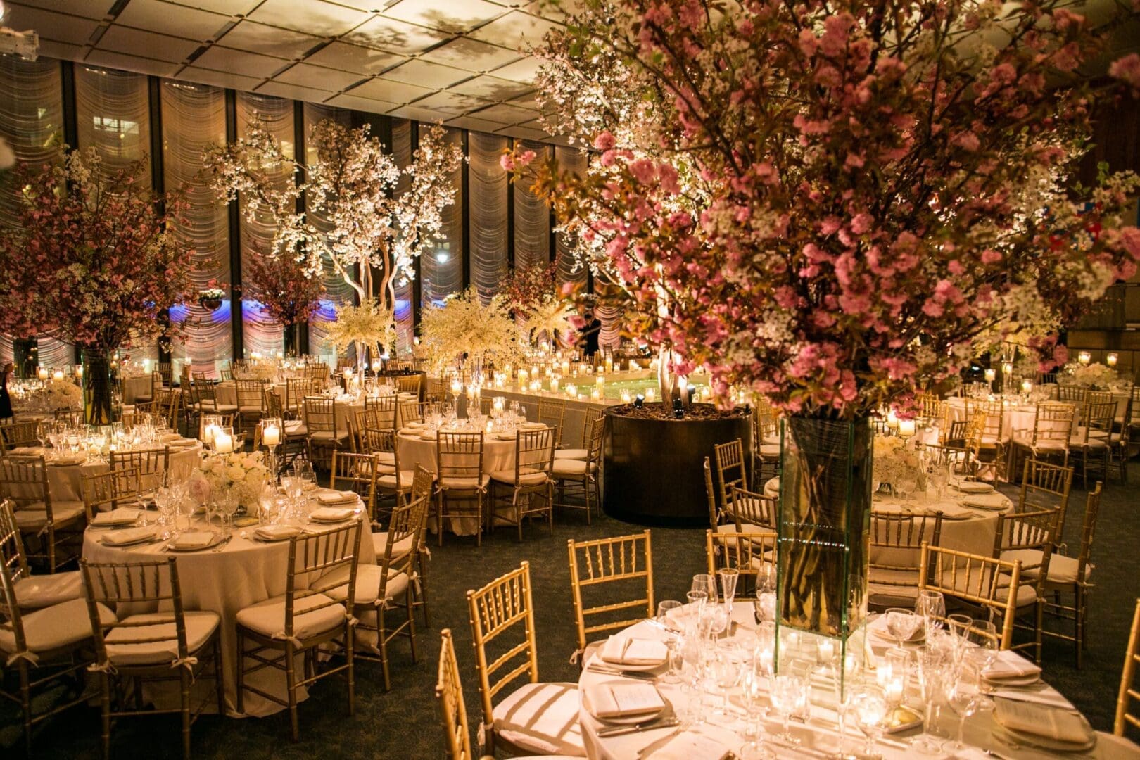 A lavish ballroom adorned with elegant tablescape ideas and an abundance of flowers, perfect for a wedding celebration.